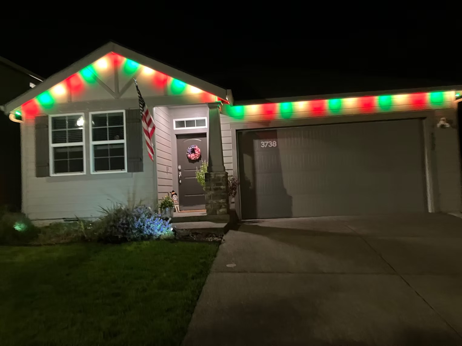Red, green and warm-white lights around a home’s entrance