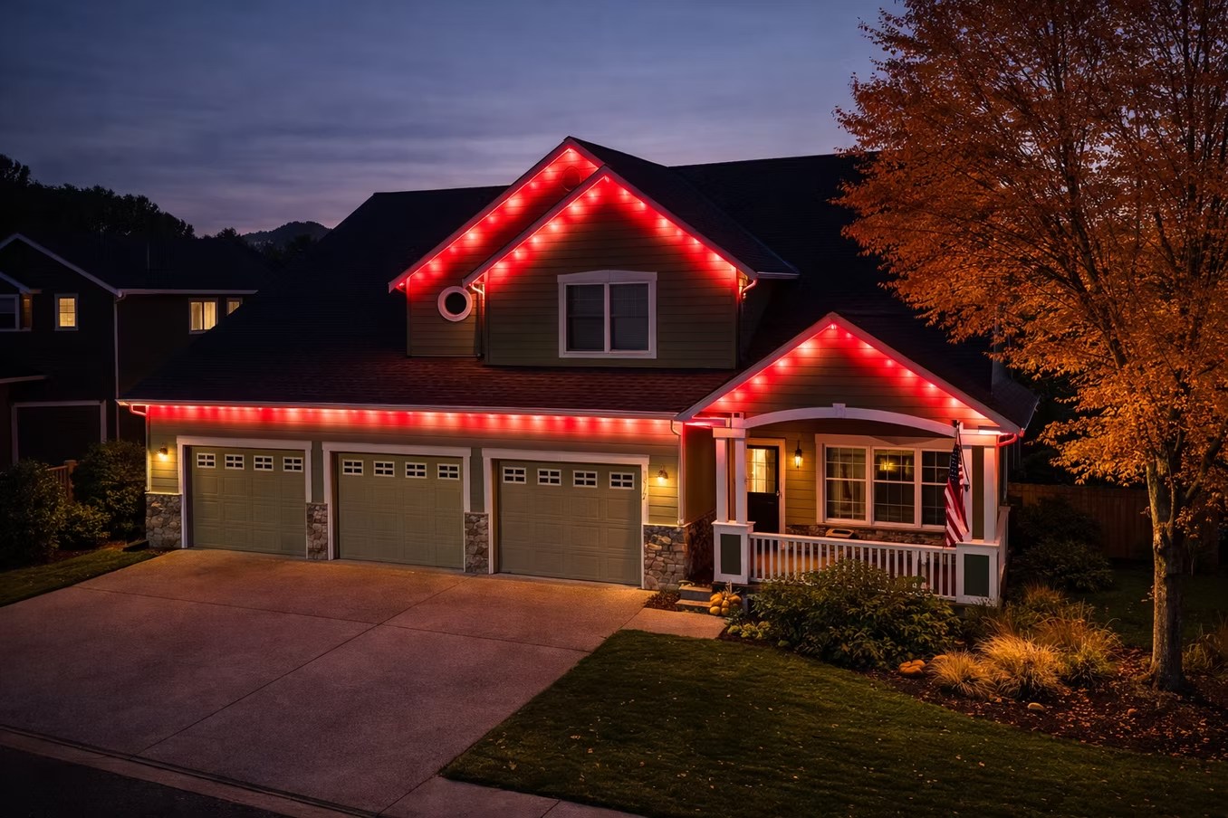 Red roofline lighting on a two-story home at sunset